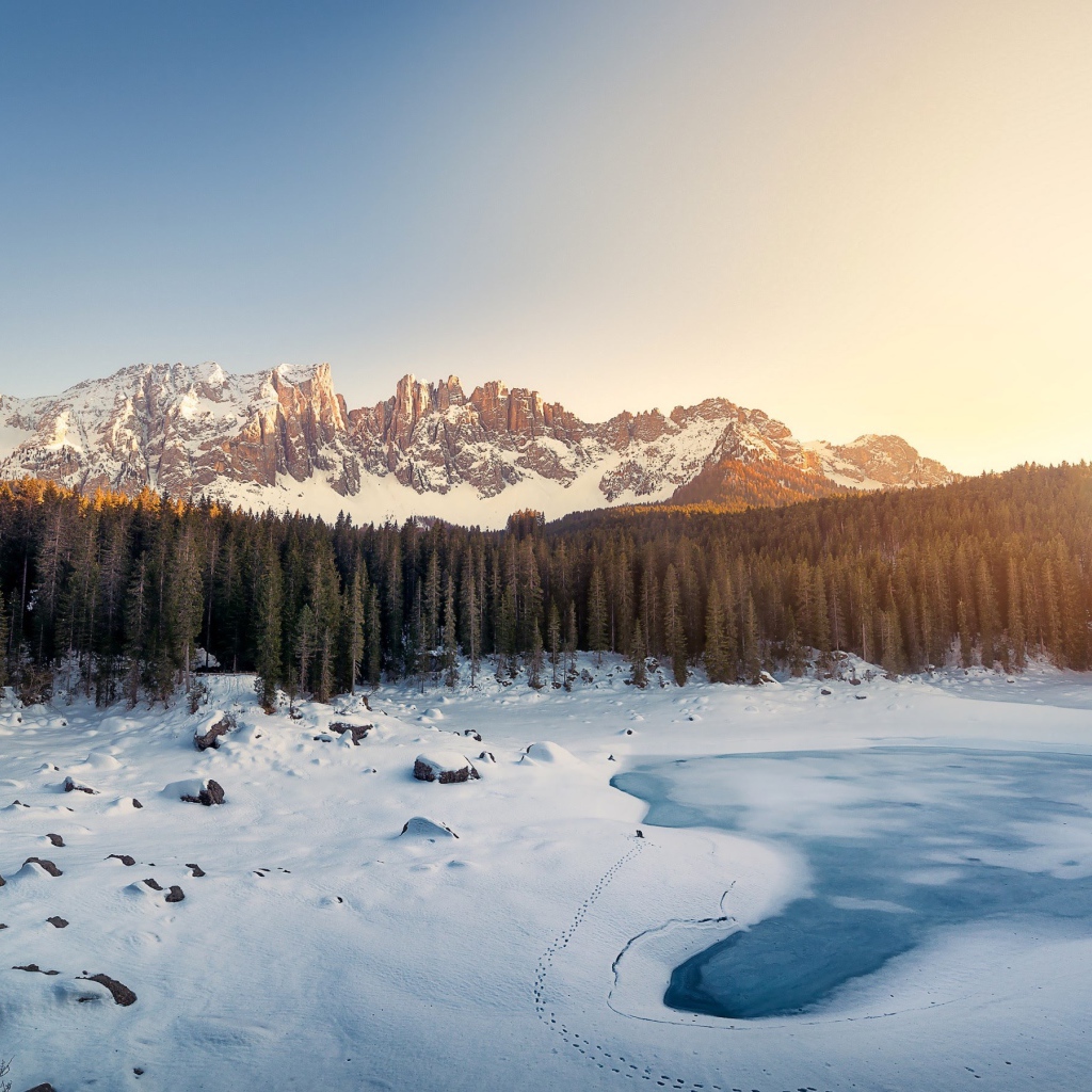 Mountain range of the Dolomites and the frozen lake