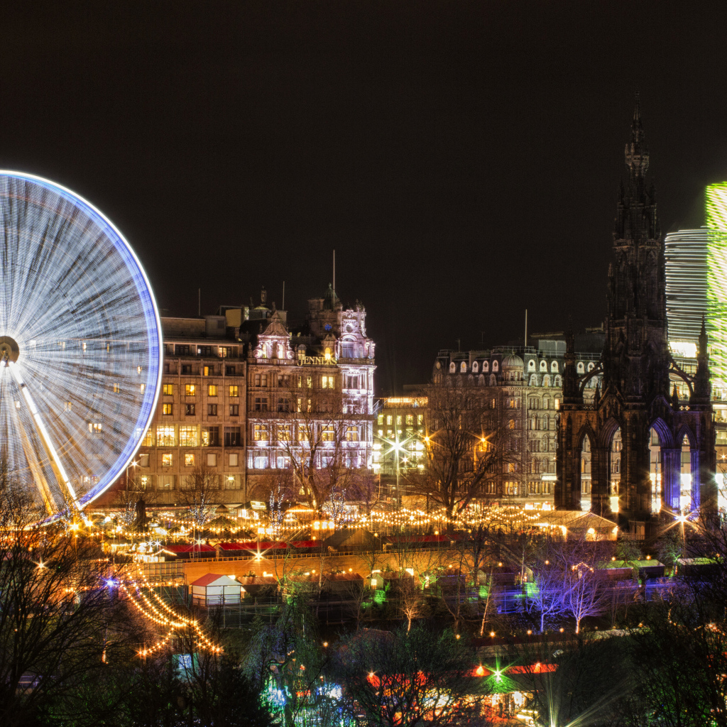 Колесо обозрения вечером на фоне города Эдинбург, Шотландия