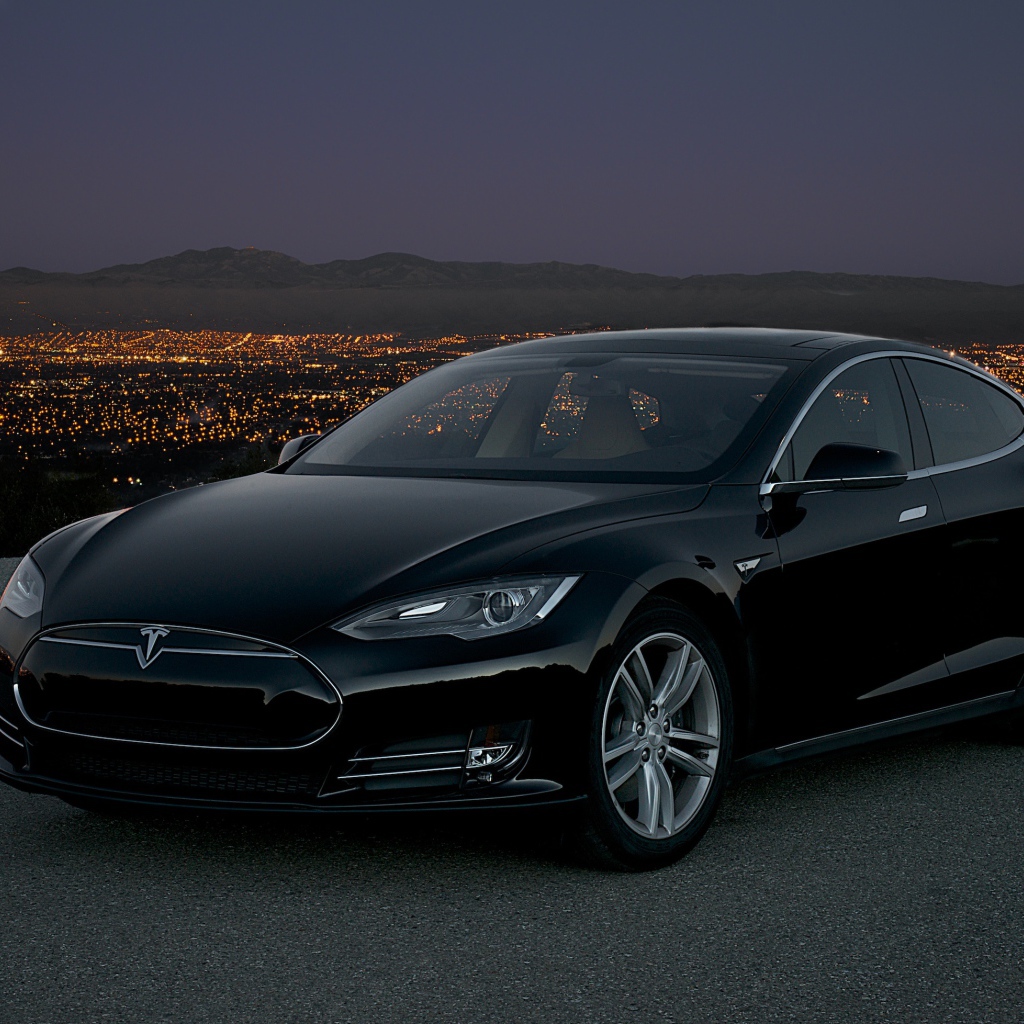 Black stylish electric Tesla Model S on the background of night city
