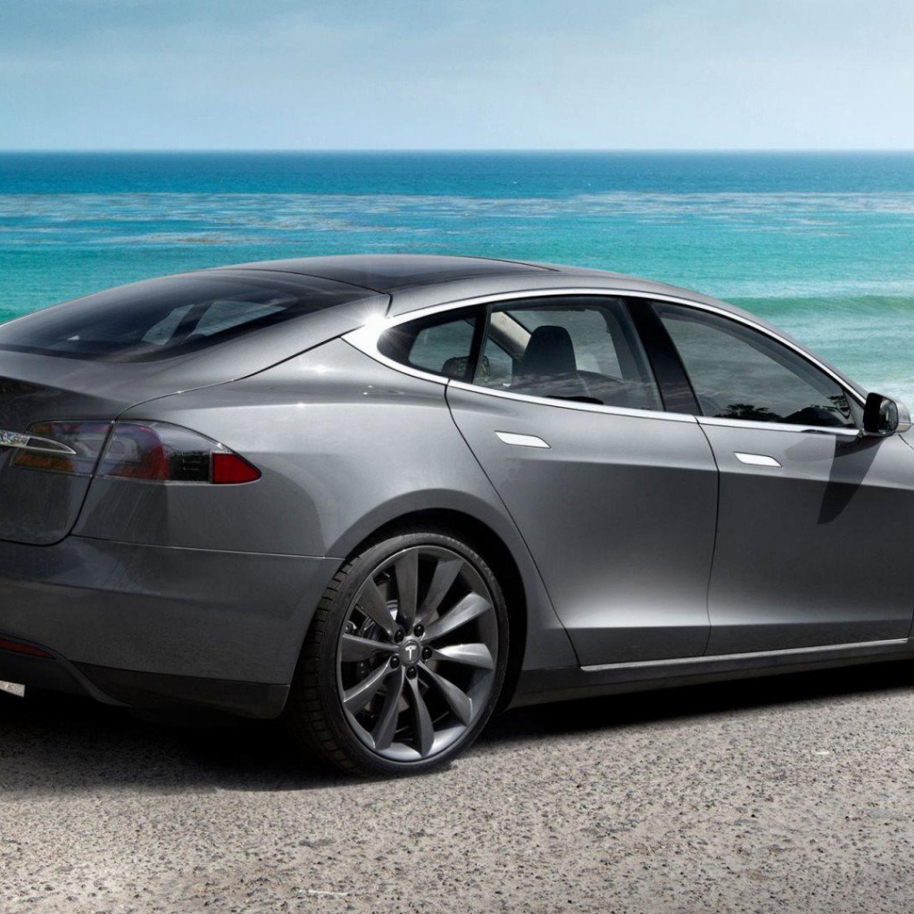 Tesla Model S electric car on background of ocean