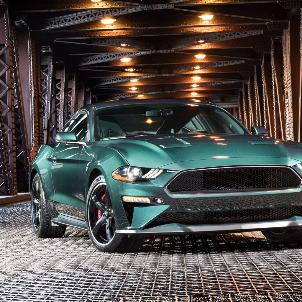 Зеленый спортивный автомобиль Ford Mustang Bullitt, 2018 на железном мосту