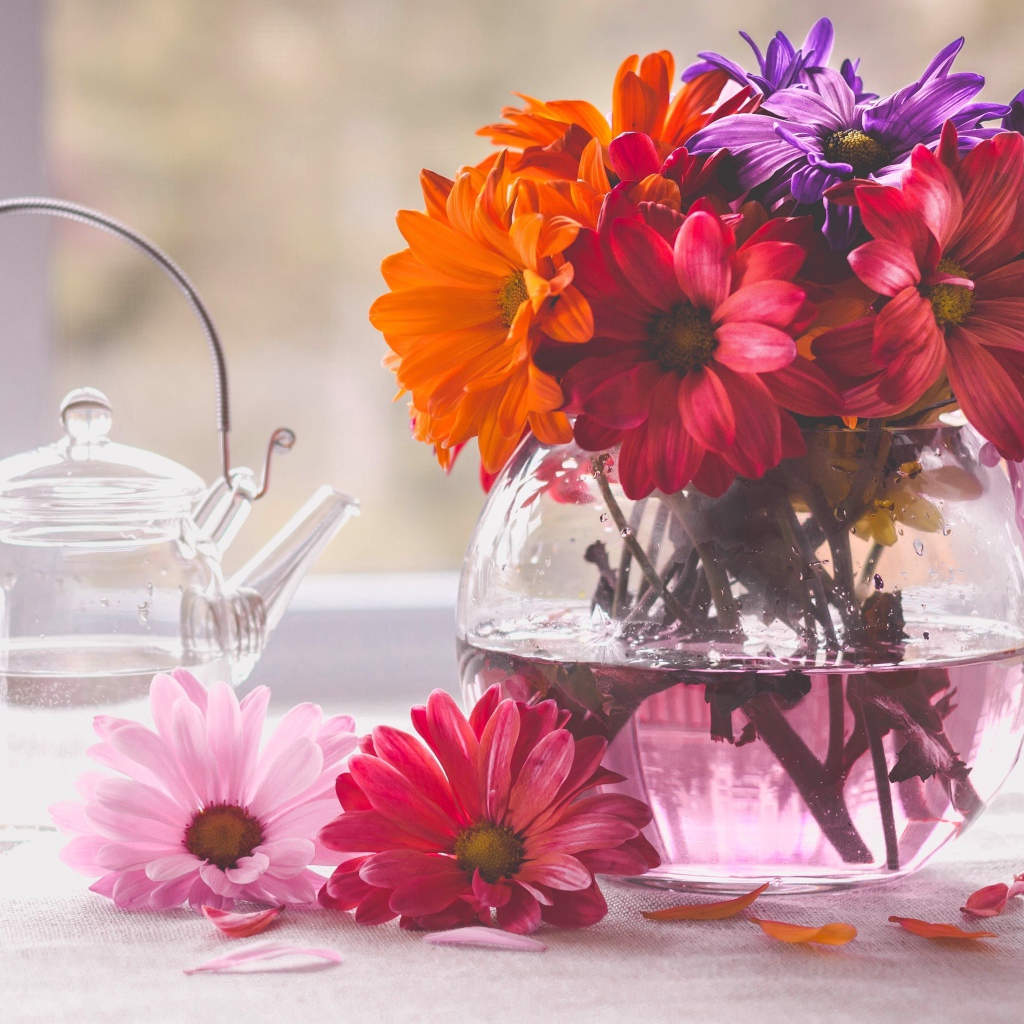A bouquet of flowers in a glass vase on a table