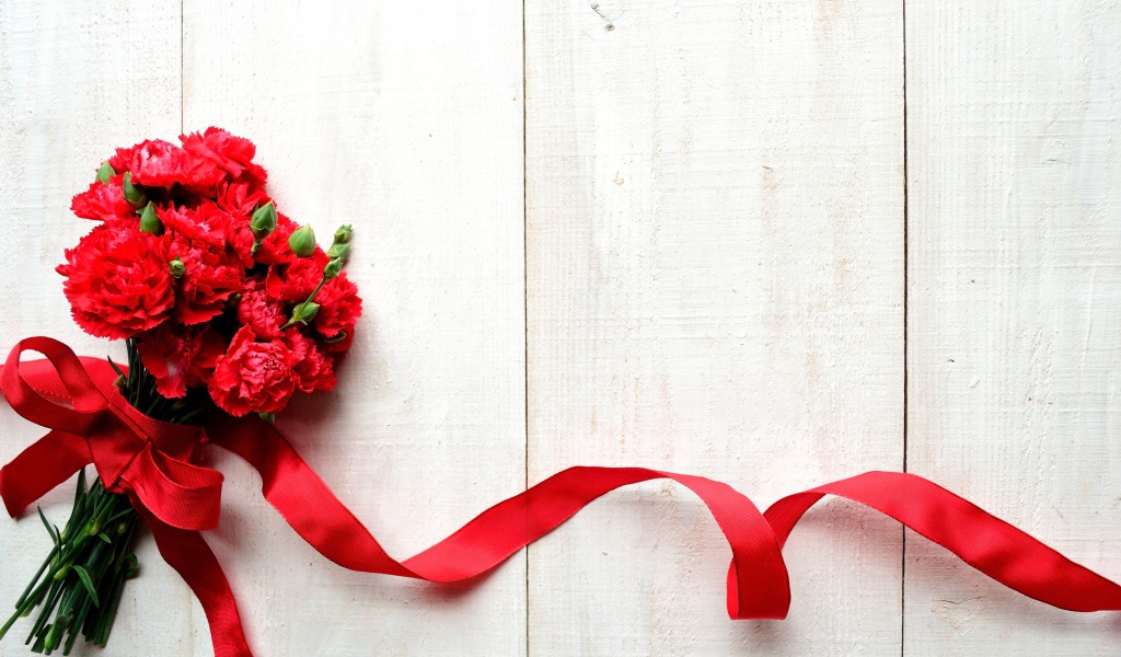 Bouquet of red carnations with red ribbon, background for a greeting card