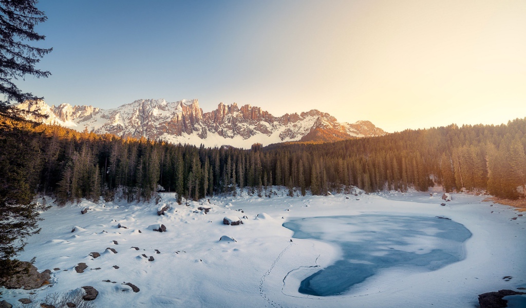 Mountain range of the Dolomites and the frozen lake