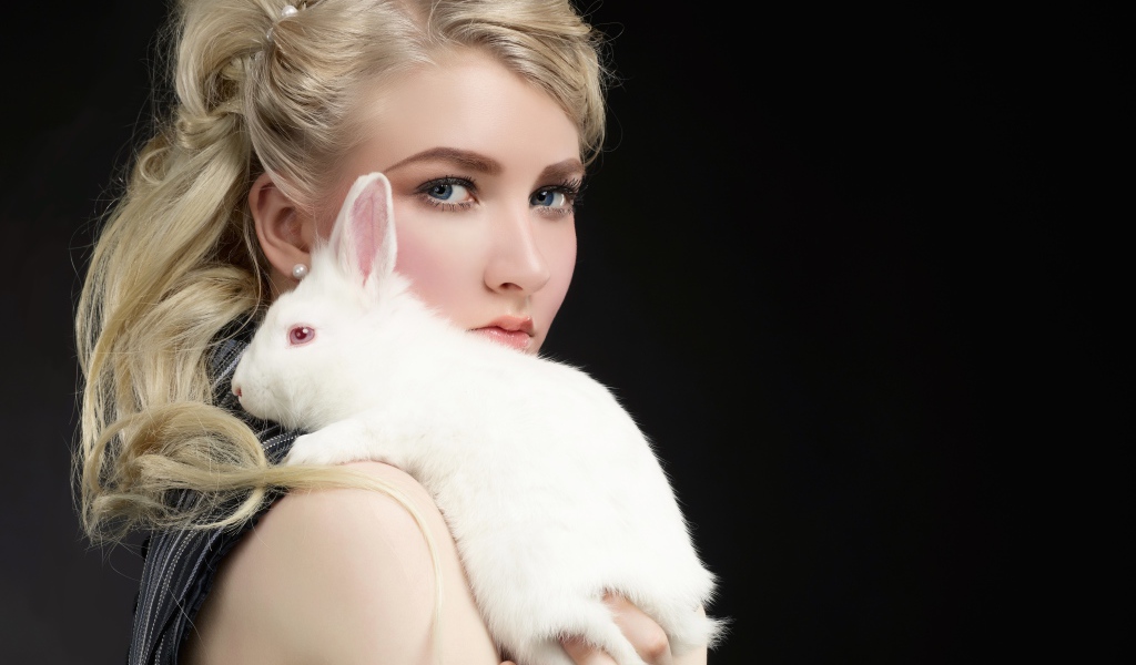Beautiful blonde with a white rabbit on her shoulder