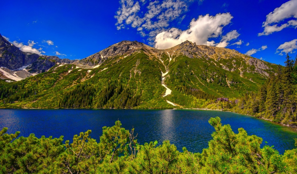 View of the lake near the Tatry mountain against the background of a beautiful blue sky