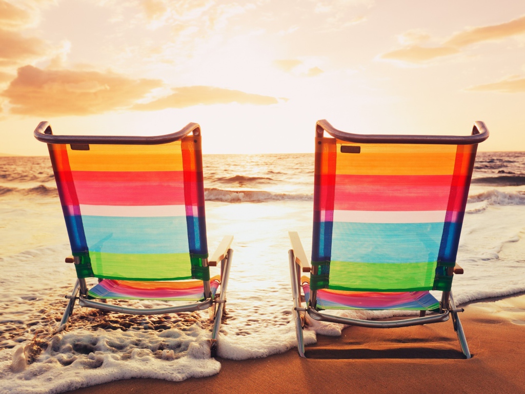 Deck chairs made of transparent plastic on the beach