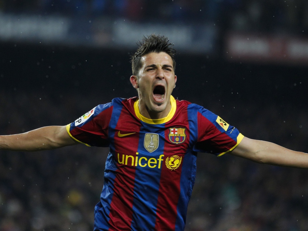 Football player David Villa rejoices with a goal scored