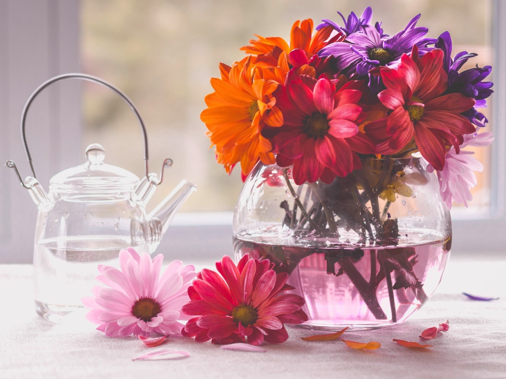 A bouquet of flowers in a glass vase on a table