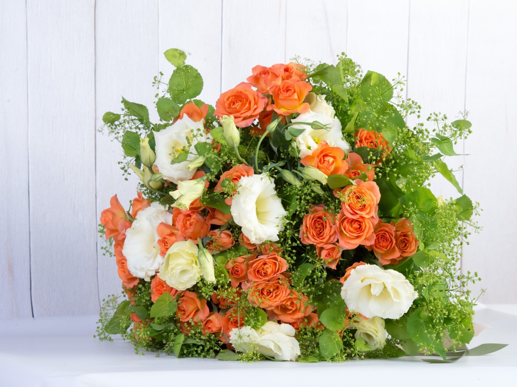 A large beautiful festive bouquet of orange roses and flowers of eustoma