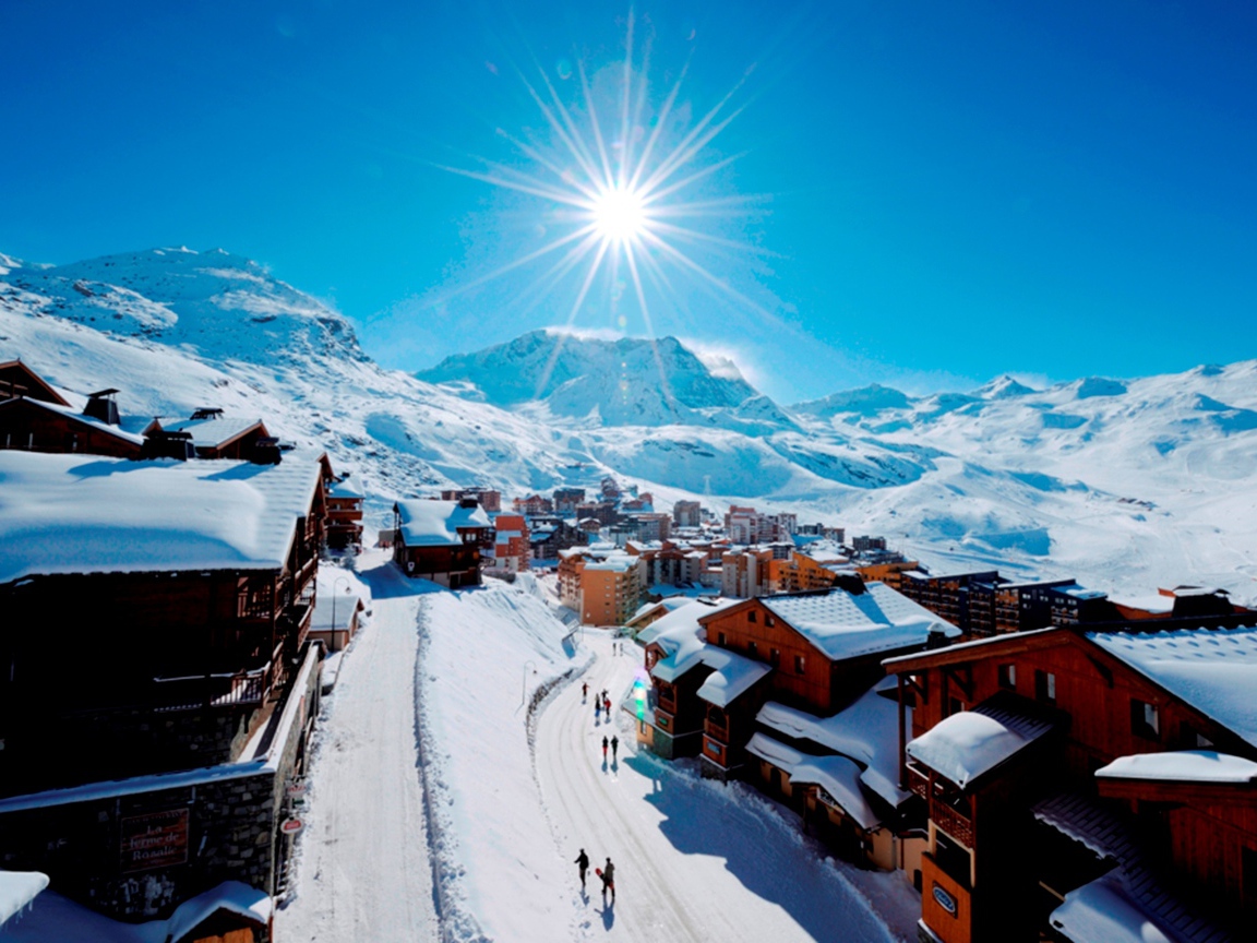 Sun over the city in the ski resort of Val Thorens, France