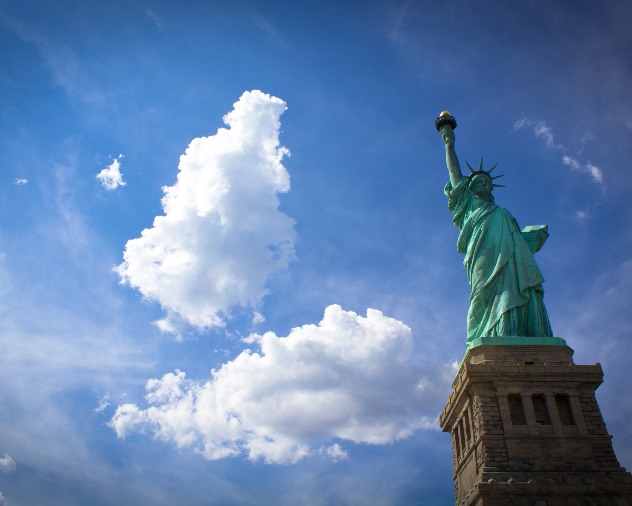 Statue of Liberty on the background of clouds, New York, USA