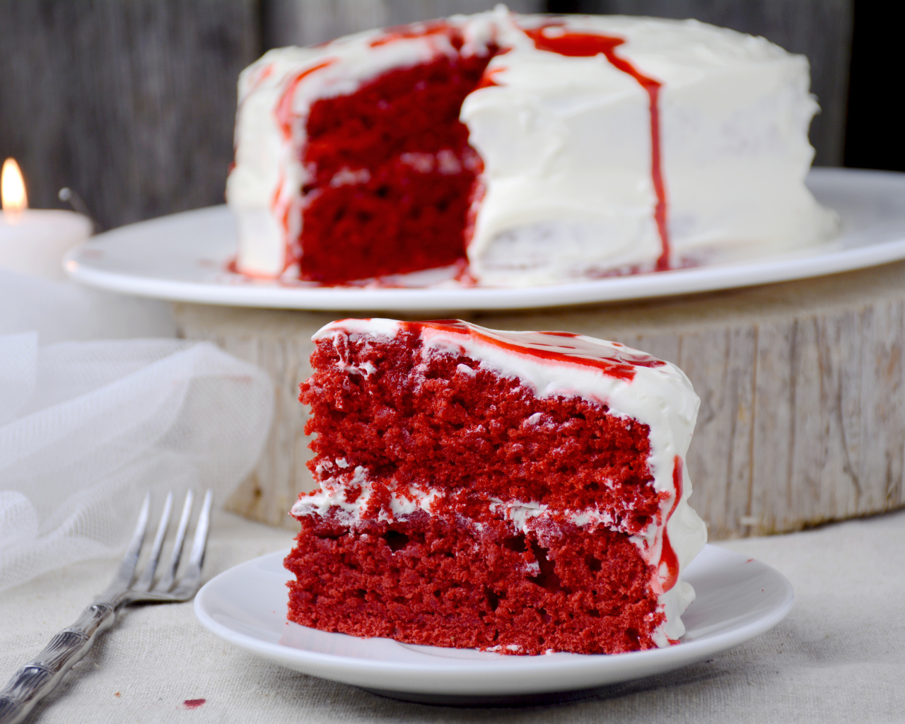 Кусок торта красного цвета с белым кремом 