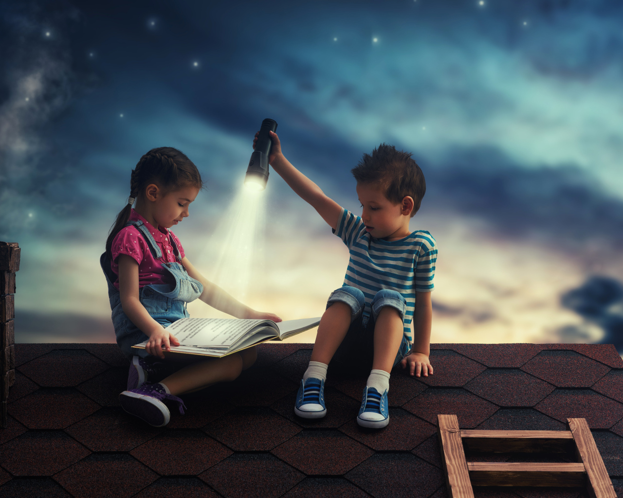 Мальчик и девочка ночью читают книгу на крыше