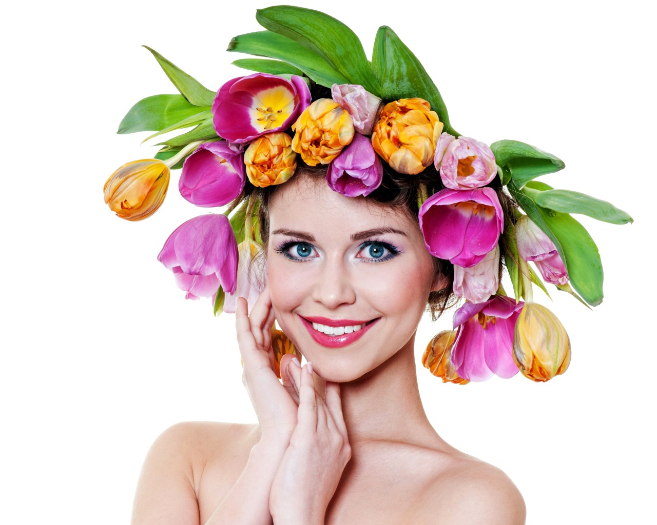 Blue-eyed smiling girl with a wreath of tulips on her head