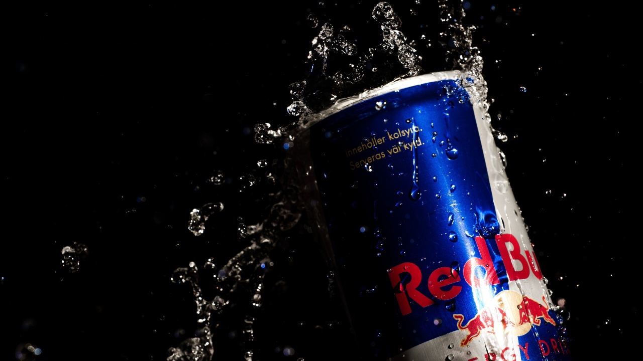 Напиток Red Bull в каплях воды