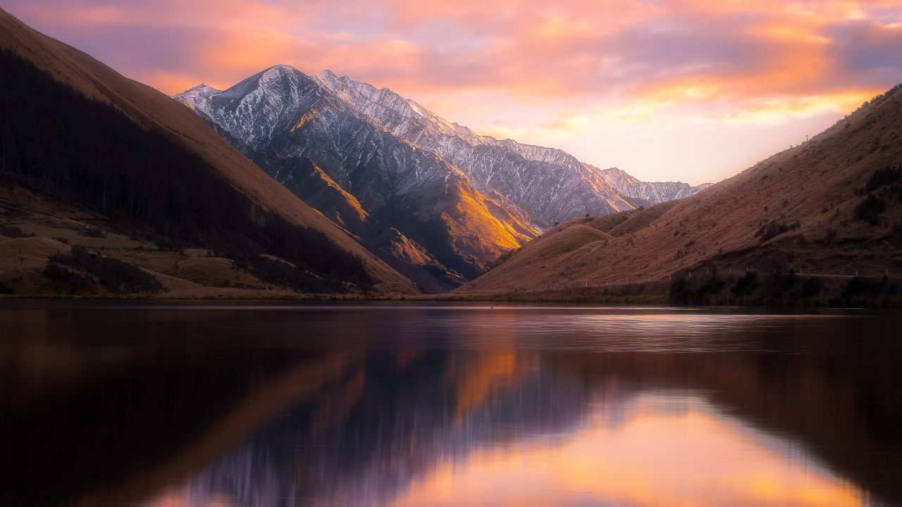 Тихая вода в озере Kirkpatrick на фоне гор, Новая Зеландия