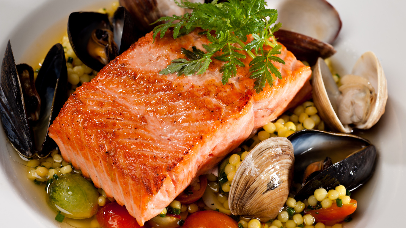 Кусок красной рыбы с морепродуктами и овощами 