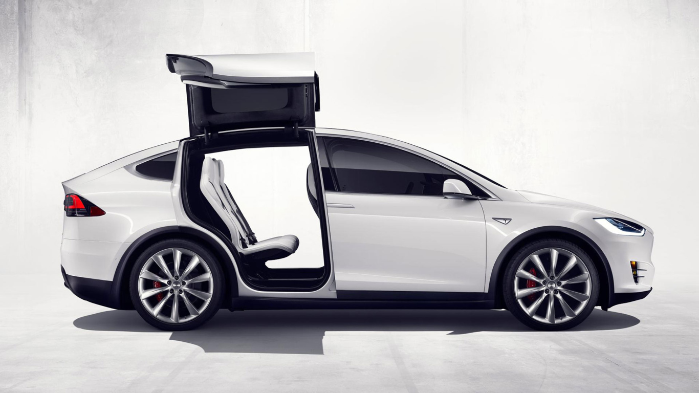 White Tesla electric car with open doors
