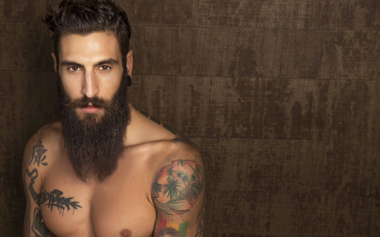 A young guy model Matteo Marinelli with a beard and tattoos on his body