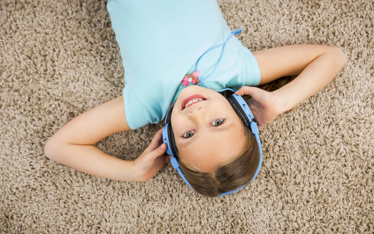 Smiling girl in big blue headphones