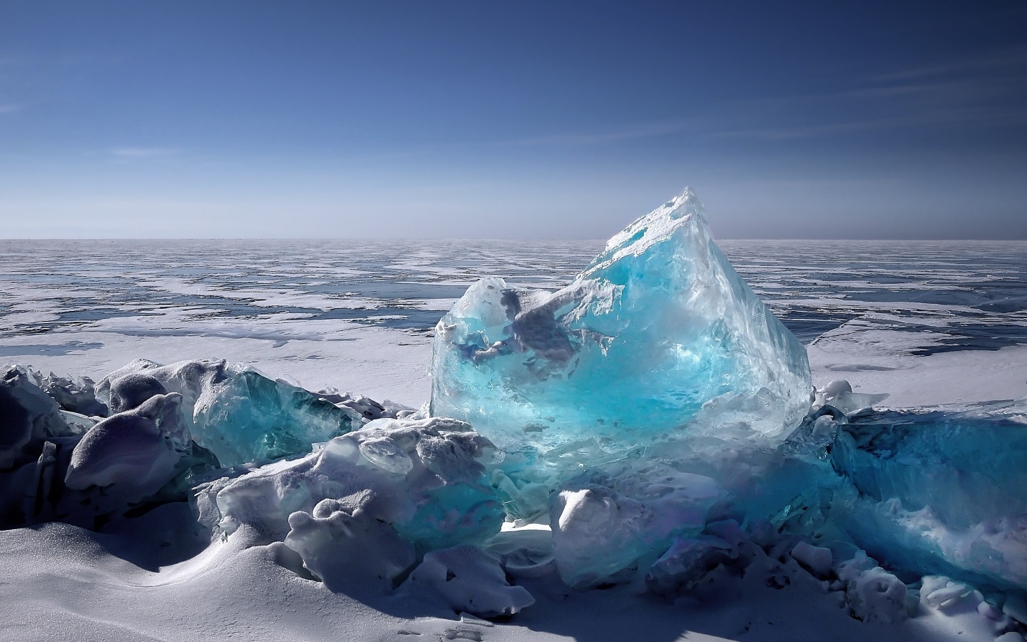 Большая голубая льдина на берегу океана