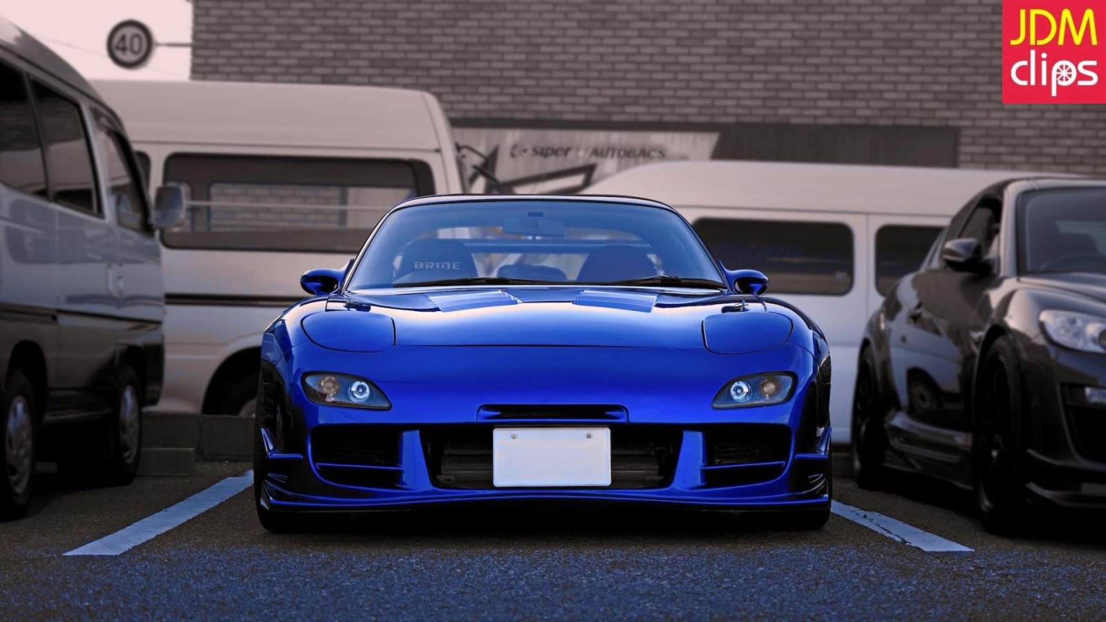 Blue Mazda RX-7 in the parking lot