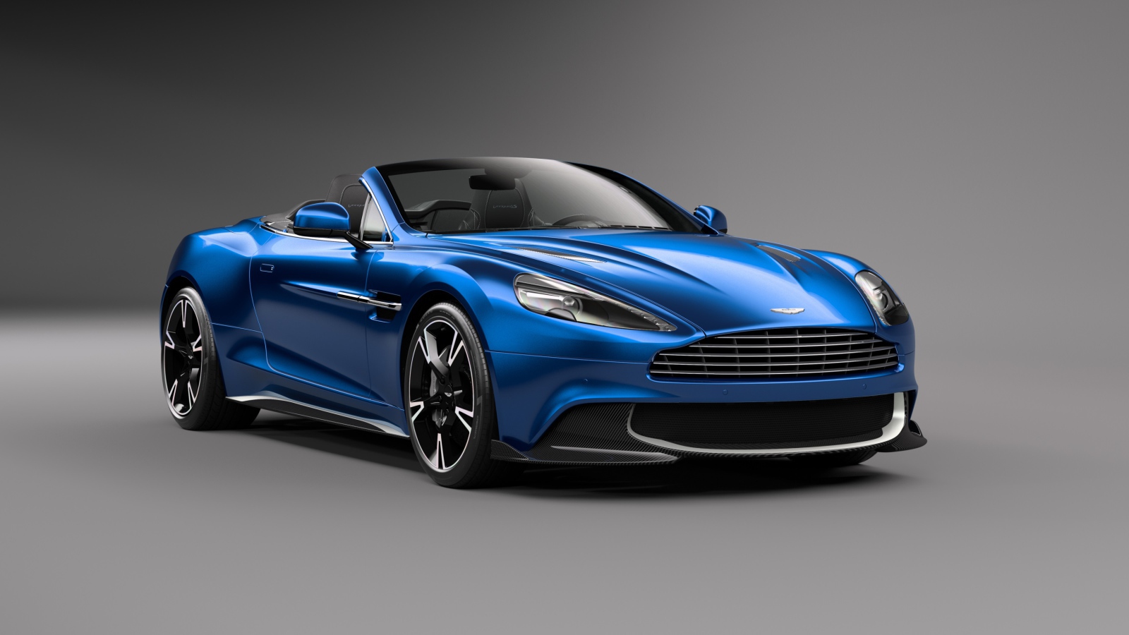 Синий кабриолет  Aston Martin Vanquish S Volante на сером фоне 