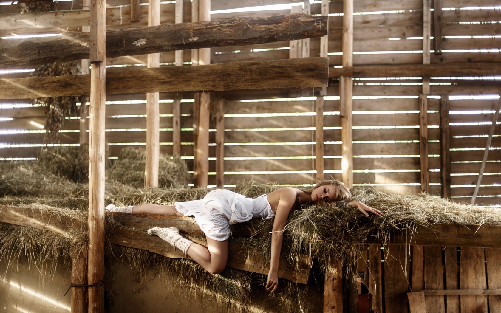 Girl sleeping on the hay in the barn
