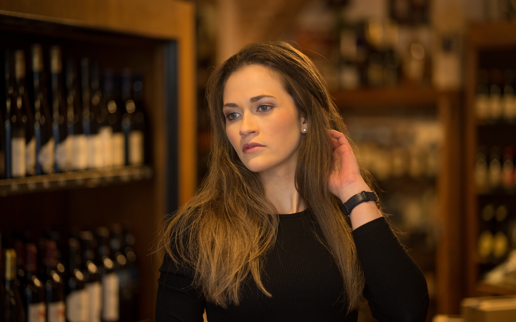 Beautiful brunette girl in a wine cellar