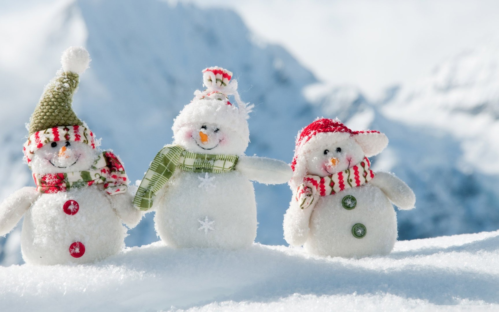 Three cheerful snowman on snow