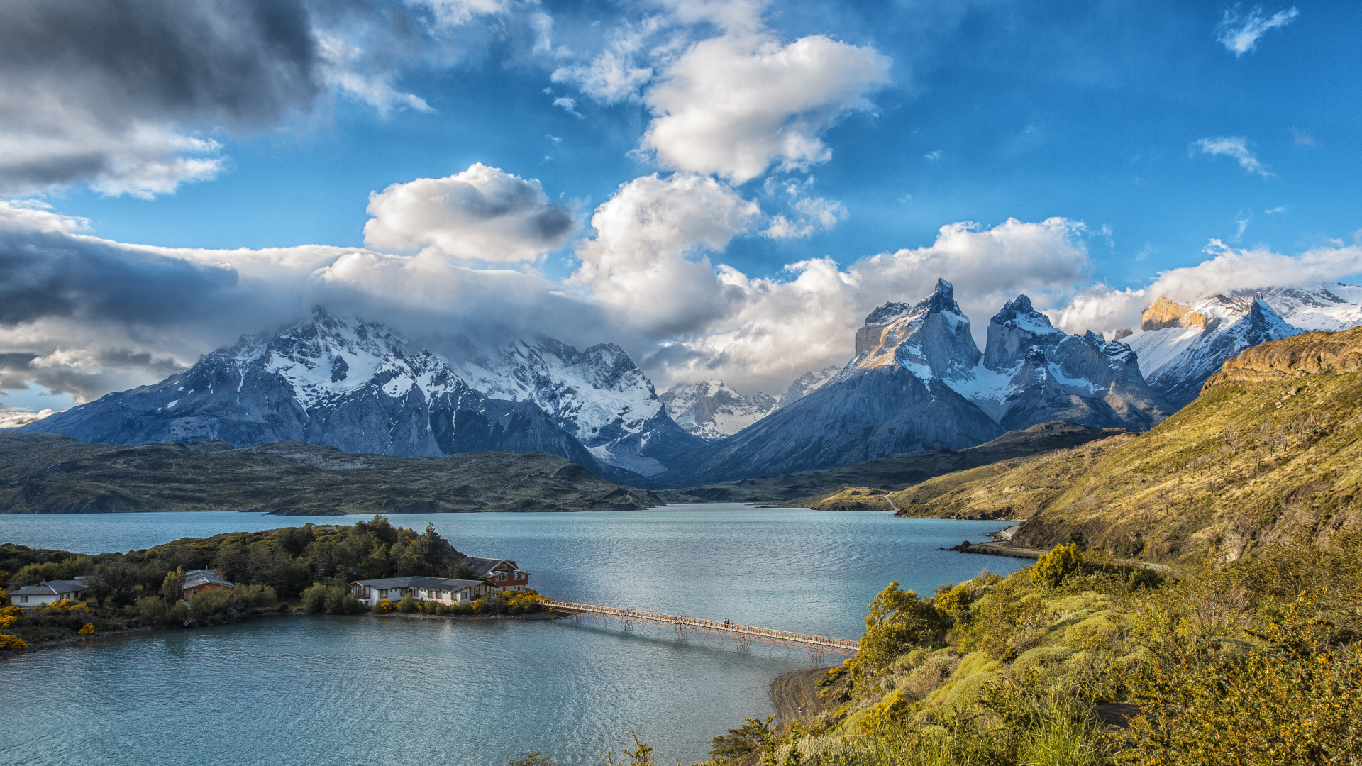 Горы под красивыми белыми облаками у озера в национальном парке Торрес-дель-Пайне, Чили