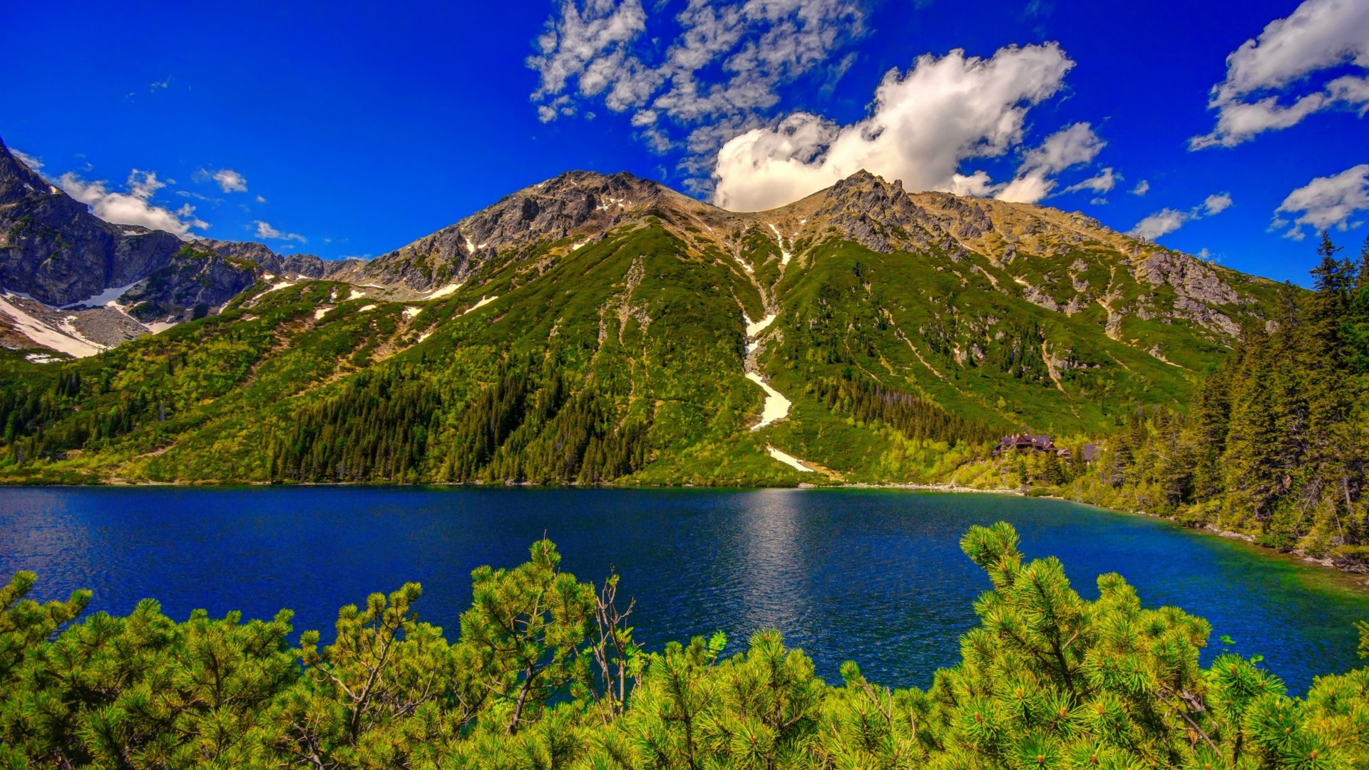 View of the lake near the Tatry mountain against the background of a beautiful blue sky
