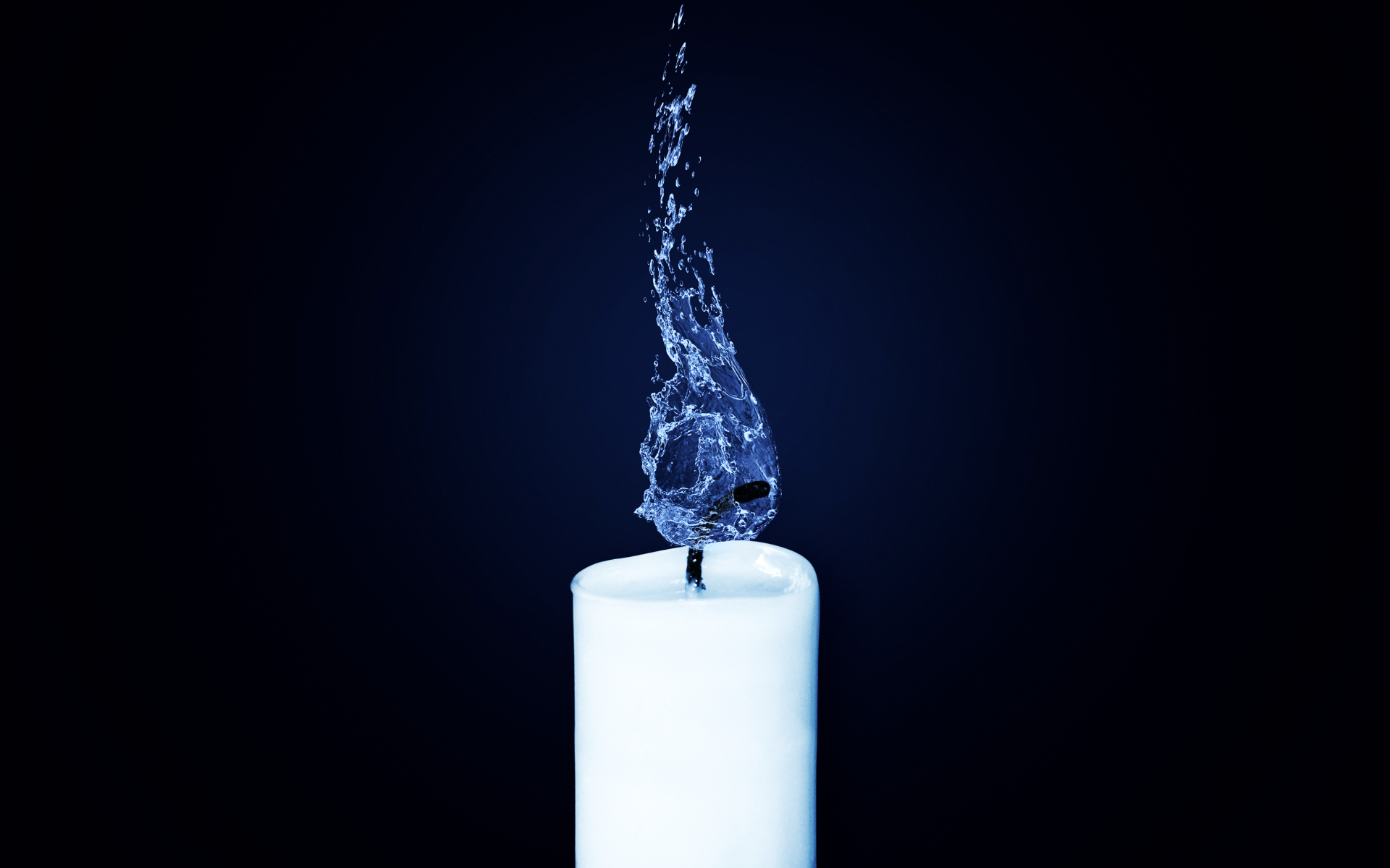 White candle burns with a flame of blue water
