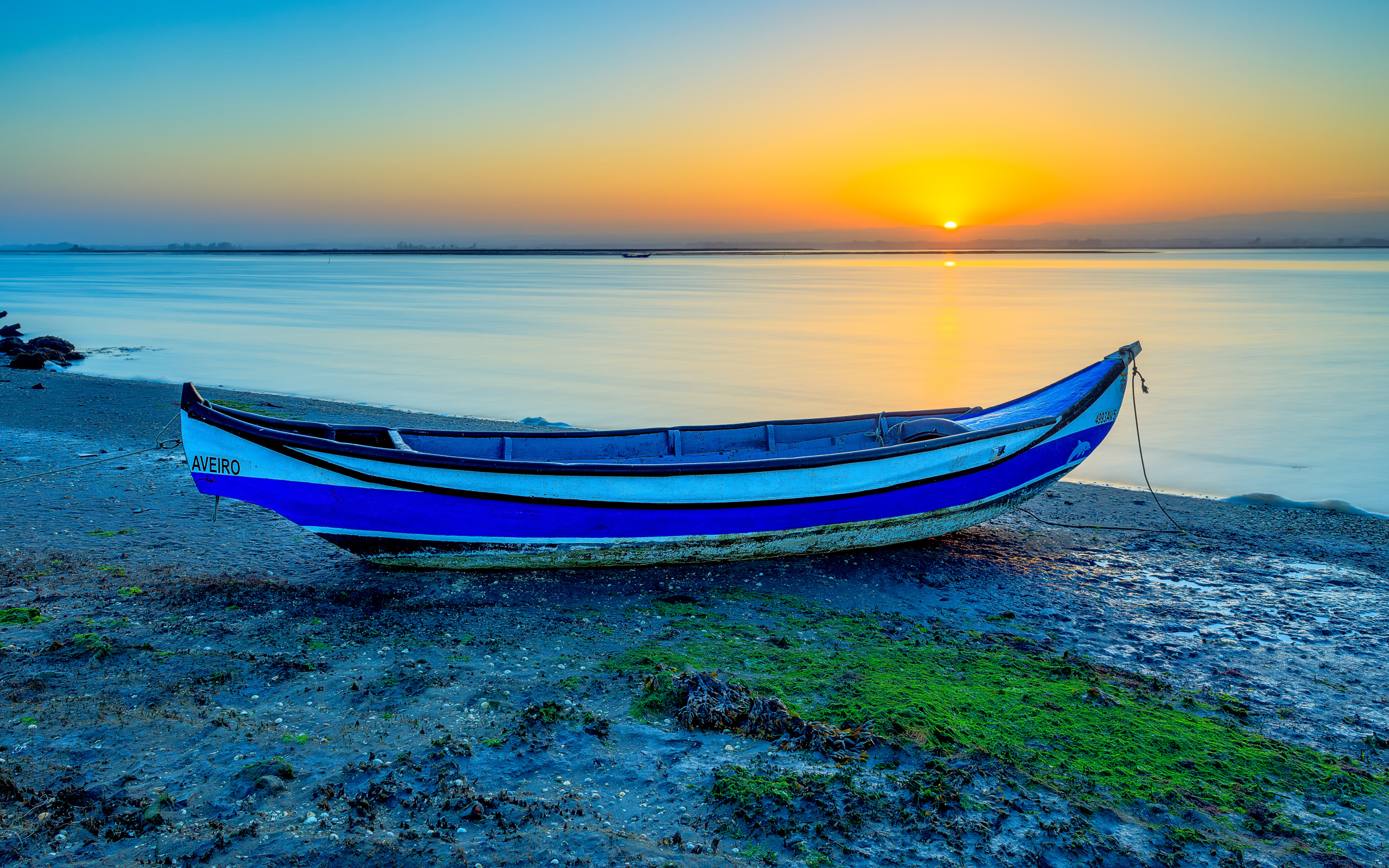 Boat on the river bank at sunset