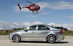 Silver Volvo S80 and a helicopter