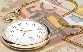 Gold watch and money