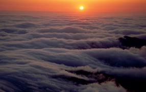 	 Sunset in the mountains above the clouds