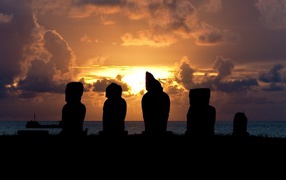	 Silhouettes of statues at sunset