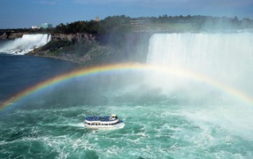 Boat under the rainbow waterfall
