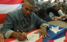 Boxer Felix Trinidad is signing the flag