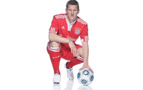 The football player of Bayern Bastian Schweinsteiger with a ball