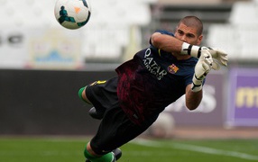 The player of Barcelona Victor Valdes takes all of the football balls