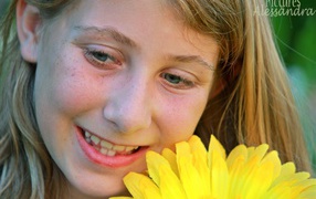 Girl with freckles and a flower