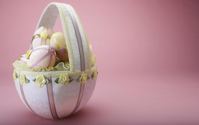 Basket of eggs on a pink background for Easter