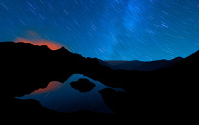 Starry night sky and mountains