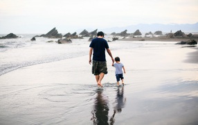 Father and son are walking on the water
