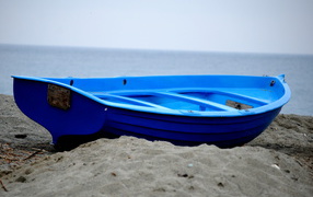 Blue boat on the beach at the resort of Celle Ligure, Italy