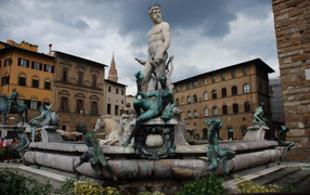 Monument on the background buildings in Florence, Italy