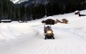 Snowmobiling in the ski resort of Val di Fassa, Italy